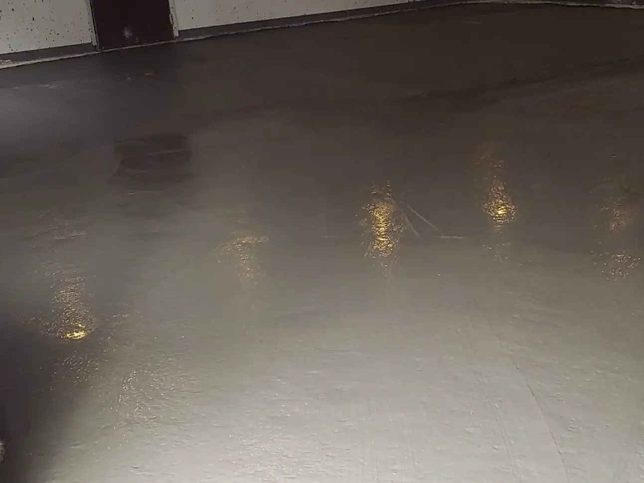 A commercial pool area at a hotel after pool removal, now featuring a smooth, paved surface where the pool once was. The space is clean and prepared for new landscaping or repurposing.