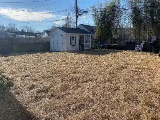 After photo of a backyard in Virginia where Remove A Pool has completed a pool demolition, with straw covering the newly leveled ground.