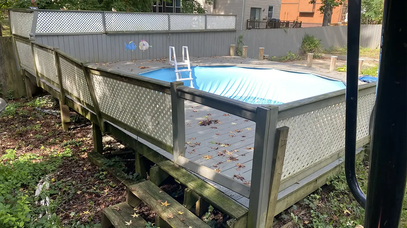 Above-ground pool with surrounding deck