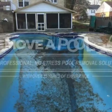 An empty swimming pool in Potomac, MD, prepared for the start of the demolition process. An in-ground pool in Potomac before removal, showing a partially drained and dilapidated structure. Remove A Pool starts the pool removal process.