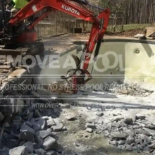 Heavy machinery begins breaking down the concrete pool structure as part of the demolition process. The in-ground pool demolition has begun in Potomac, with large machinery breaking up the pool structure.