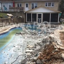 Debris from the demolished pool is cleared away, making space for further restoration work. Demolished pool debris being removed from the site in Potomac. Our team is clearing out broken concrete and debris.