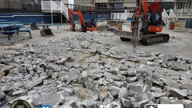 Two excavators working in a concrete pool demolition project, breaking up the floor and surrounding walls.