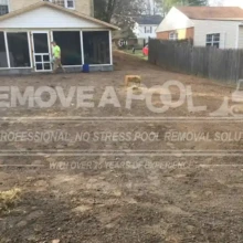 Final grading and land smoothing complete the major steps of the pool removal. The land is being graded and smoothed after pool demolition.