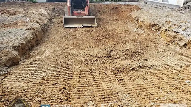 Step 13: Our skid loader is grading the area where the pool was removed. Our skid loader graded the area.
