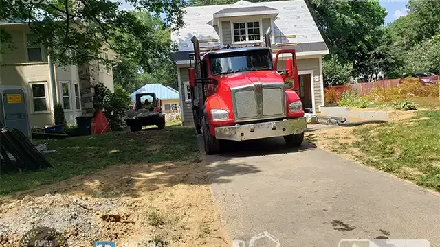 Step 9: We began removing the concrete and rubble, loading it into our dump truck. We loaded concrete and rubble into our dump truck for disposal.