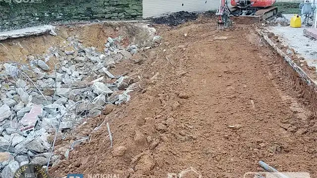 Step 15: With the deck removed, we begin the main stage of filling in the pool itself, ensuring it is compacted as we go. We move the large concrete blocks inside the pool, to fill it in.