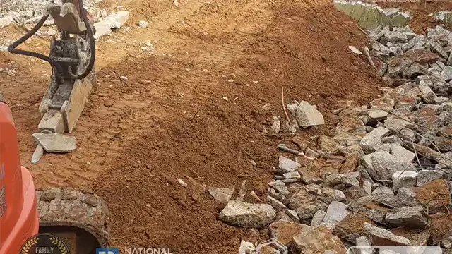 Step 17: Our team gathers and moves the larger concrete blocks inside the pool area, while the excavator levels the area where the blocks were removed. We remove the large concrete blocks here also and fill it inside the pool.