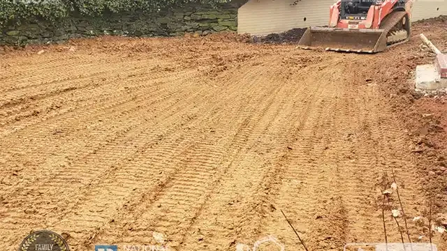 Step 23: Our skid loader continues to level the site, ensuring a smooth and even surface. Our skid loader is doing its job leveling the area