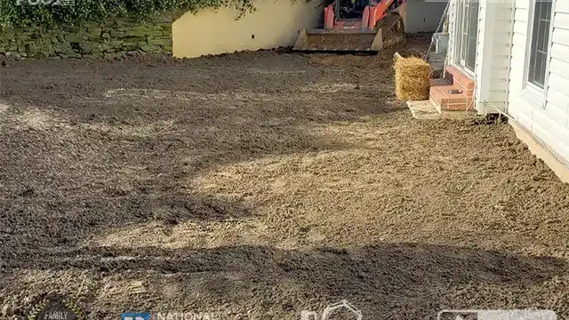 Step 29: Grass seeding begins, with straw being spread across the area to protect the seeds and encourage healthy growth. Grass seeding was applied, and straw is getting prepared to cover the area.