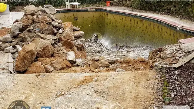 Step 4: The first step of demolition involves breaking down one side of the pool, clearing the way for our heavy equipment, such as the excavator. We broke one side of the pool to clear the way for the excavator.